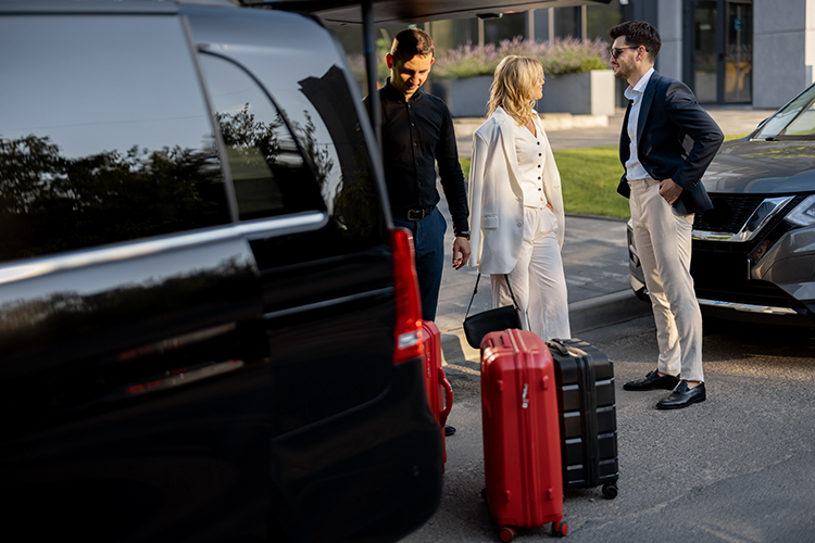business-couple-near-minivan-taxi-with-suitcases-chauffeur